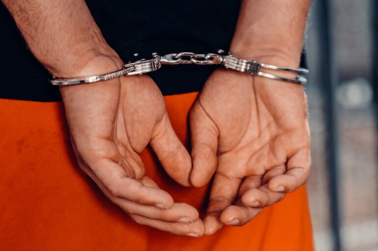 Photo by Kindel Media: https://www.pexels.com/photo/close-up-shot-of-a-person-with-handcuffs-7785052/